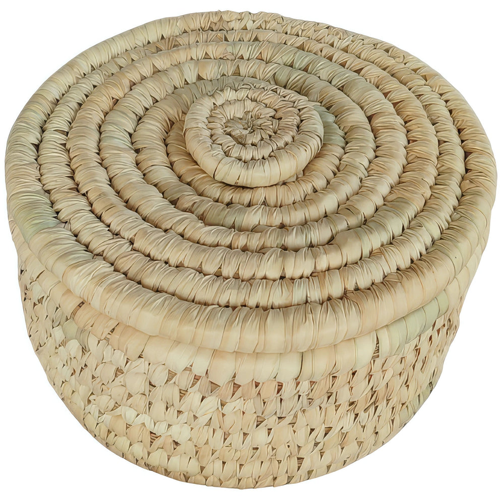 Piccolo cesto rotondo in foglie di palma, coperchio chiuso intrecciato a spirale e toni beige chiaro e paglierino.