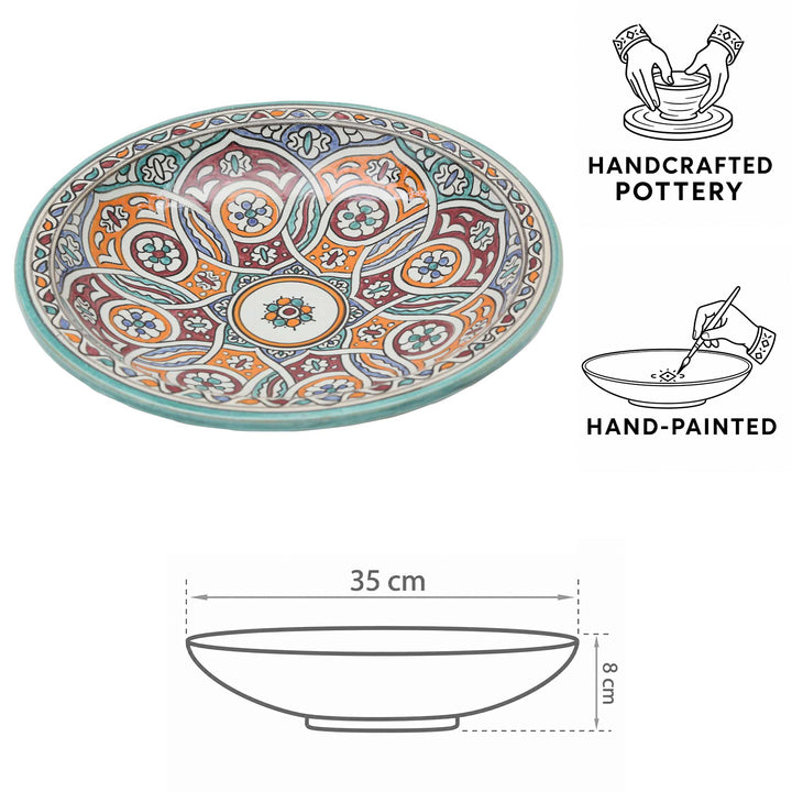 Ciotola in ceramica marocchina dipinta a mano con motivi circolari nei toni del turchese, dell’arancione e del bordeaux, Ø 35 cm e 8 cm di altezza