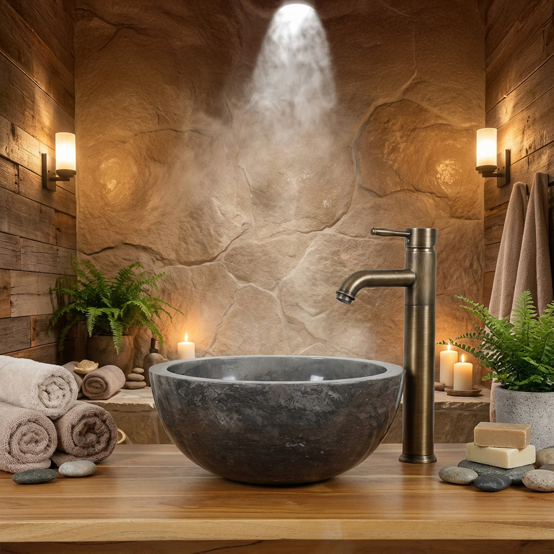 Rundes Steinwaschbecken als Aufsatz auf Holzkonsole mit Messingarmatur im warmen Spa-Badezimmerambiente
